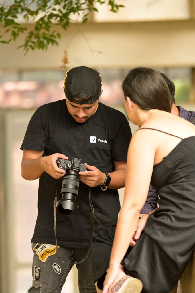 Photographer showing captured images to a model during an indoor photo session.
